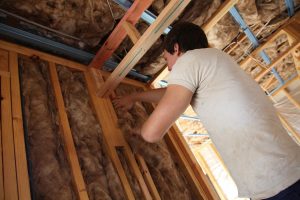 Tradesperson installing insulation