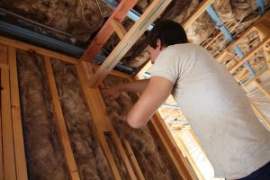 Dude installing insulation